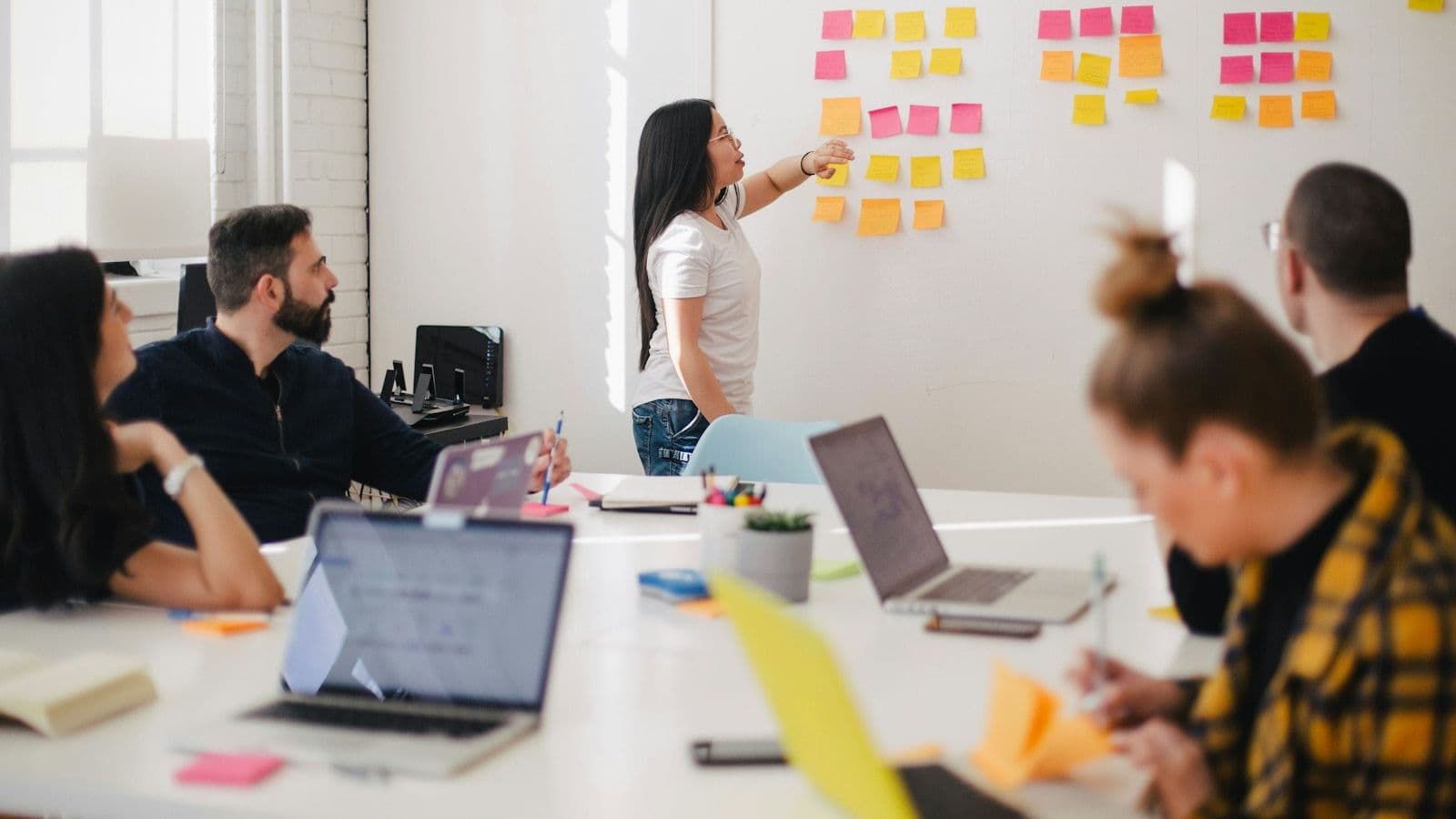 A team working through a plan on sticky notes in a studio.